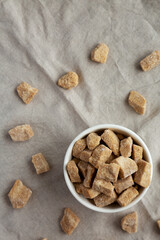 Raw Organic Demerara Granulated Brown Sugar in a Bowl, top view. Flat lay, overhead, from above. Copy space.