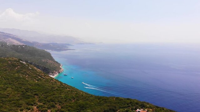 Aerial Drone View of Gjipe Beach and Canyon, Dhermi, Albania - Hidden Paraside with boats, tourists, sunbeds and blue sea