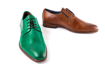 Male brown and green leather shoes on white background, isolated product. Differentiated footwear and exclusive design.