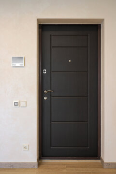 Black front door in the hallway of the apartment