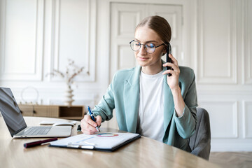 A female financier is working on a finance report in a company in the office of a manager's...