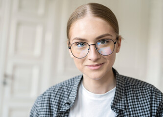 Portrait of a freelance woman with glasses working in an office