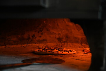 cooking authentic cheese and tomato Margherita pizza in a pizza oven, Italian cuisine, Margherita pizza recipe