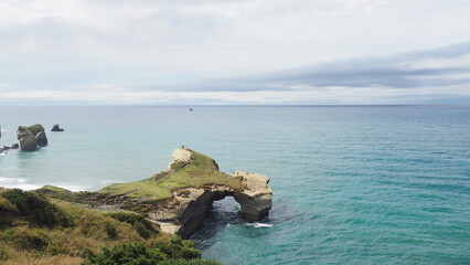 Tunnel Beach. Dunedin, Otago, New Zealand.

View of a picturesque sandstone cliffs, rock arches and...