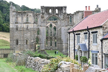 Fototapeta na wymiar Rievaulx Abbey ree-VOH was a Cistercian abbey in Rievaulx, situated near Helmsley in the North York Moors National Park, North Yorkshire, England