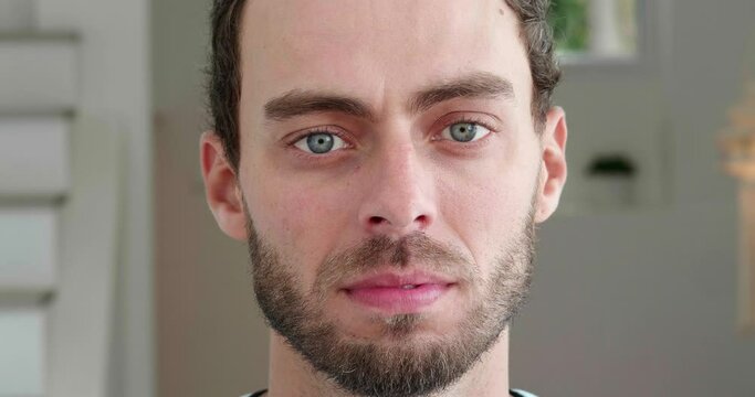 Headshot. Close-up portrait of a charming young Caucasian man, 20-30 years old, confidently looking at the camera with sincere neutral emotions. Human face. Confidence, individuality, personality
