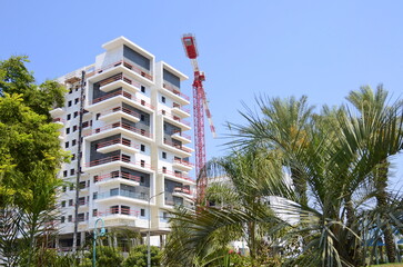Sunny day, construction site, construction crane. New building in Israel. Concept: real estate...