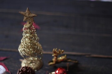 Christmas decorations placed on a black wooden table.