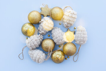 beautiful shiny gold and beige Christmas baubles on a blue background