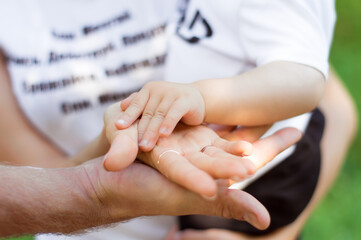 happy family together. Three hands lie on top of each other
