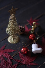 Christmas decorations placed on a black wooden table.