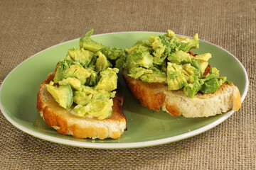 mashed fresh avocado on toasted bread