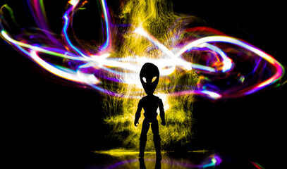 Silhouette of a humanoid with an alien head surrounded by colored lights.