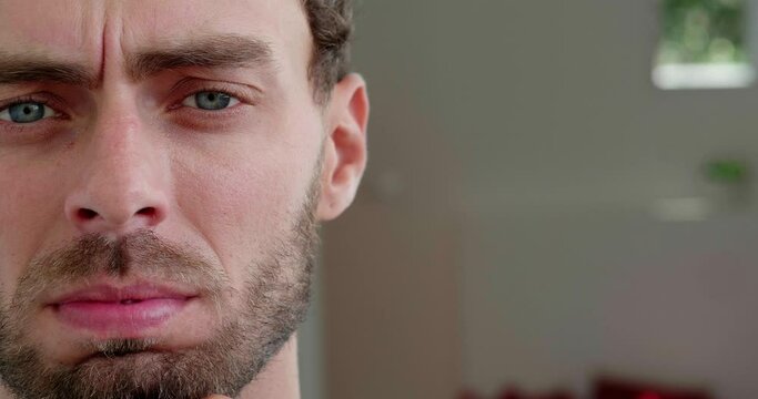 Partial view of the face of Caucasian worried, bewildered man, touching bearded chin looking pensively around with anxiety, uncertainty. Close-up. Headshot. Copy advertising space for promotional text