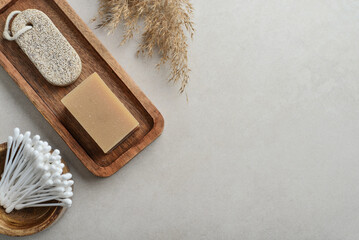 Fototapeta na wymiar Natural soap bars and pumice stone on wooden tray