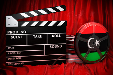 Libyan cinematography, film industry, cinema in Libya. Clapperboard with and film reels on the red fabric, 3D rendering