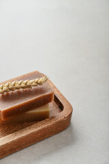 Natural handmade soap bars on wooden tray