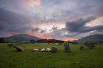 Dramatic pink and purple sunrise at Castlerigg Stone Circle in Keswick, Lake District, UK. British...