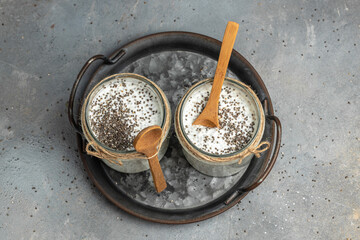 Chia seed pudding. Healthy breakfast. Yogurt with chia seeds healthy superfood. Cottage cheese smoothie in glass jars. place for text