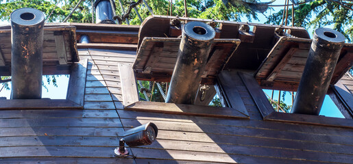 Wooden ship with guns. Medieval wooden pirate ship. Imitation of an old ship in the park. Vintage wooden warship © jockermax3d
