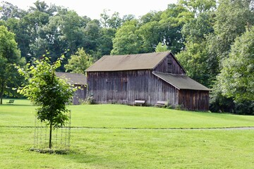 The old brown barn in the countryside on a sunny day.
