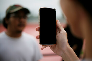person using smartphone. close up hand holding smartphone using and showing a blank phone screen