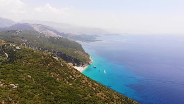 Aerial Drone View of Gjipe Beach and Canyon, Dhermi, Albania - Hidden Paraside with boats, tourists, sunbeds and blue sea