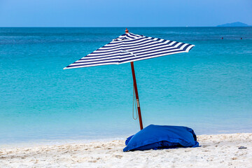 beach and umbrella in the tropical beachBeach umbrellas on the beach of the Tropical sea