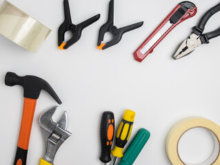 Top view of construction tools and tools highlighted on a white background with a space in the center