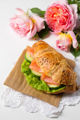 Croissant with salmon on parchment