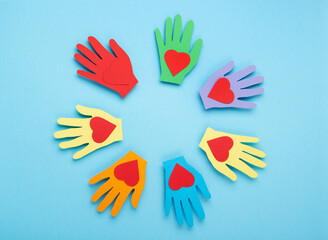 International Day of Charity, 5 September. Colorful Hands on Blue Background.