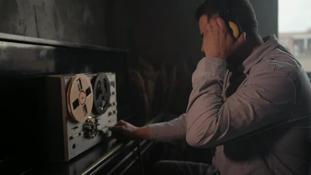 Secret agent listens on the reel tape recorder. Officer wiretapping in headphones. Spying of conversations. Intelligence gathering. Espionage concept. Report information to superiors.
