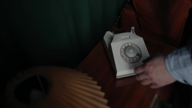 Special secret agent speaking by old landline phone. Spying or intelligence gathering. Espionage concept. Report information to superiors.
