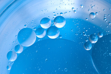 Blue oil drops on blue water. Abstract and concept for background. 