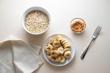 Cooking banana cookies. Top view of ingredients bananas, oatmeal, peanut butter