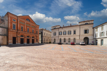 Fototapeta na wymiar Alba, Langhe, Piedmont, Italy: Vittorio Veneto cobblestone square with the Teatro Sociale (social theater) on the left and ancient buildings