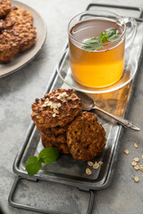 Banana, rolled oats peanut butter cookies with cup of tea. Healthy snack or breakfast