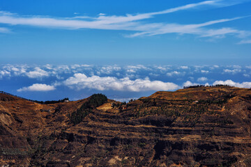 Fototapeta na wymiar Mountain landscape panorama view on the island Gran Canaria - with sky on the background - picturesque hiking route higher than clouds