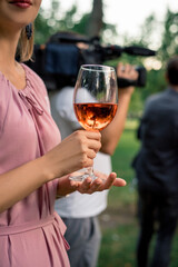 woman drinking alcohol on white background. Focus on wine glass