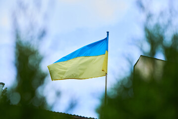 Photo of the flag of Ukraine against the background of the sky. Ukrainian symbols. Yellow-blue colors symbolize will and faith.