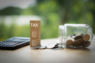 Taxes and Documents are icons on a wooden block. There is a calculator and money. financial...