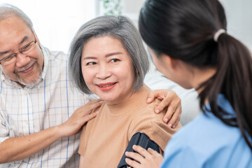 An elderly woman with a contented life having a blood pressure check by her caregiver at home with...