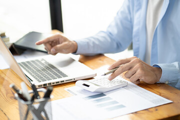 Man working by using a laptop computer Hands typing on keyboard. writing a blog. Working at home are in hand finger typewriter.
