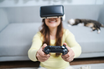 Young Asian woman wearing virtual reality touching air during the VR experience  Future technology concept.