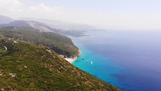Aerial Drone View of Gjipe Beach and Canyon, Dhermi, Albania - Hidden Paraside with boats, tourists, sunbeds and blue sea