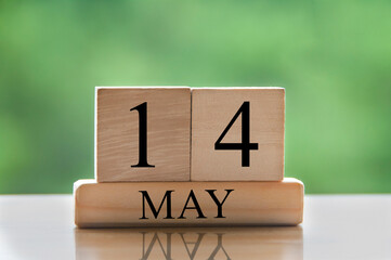 May 14 calendar date text on wooden blocks with blurred nature background. Copy space and calendar concept