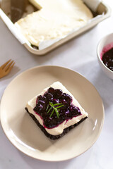 Homemade creamy cheese pie with juicy blueberry sauce and fresh blueberries. 