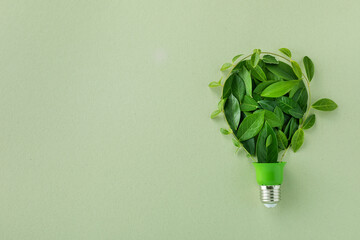 Eco lightbulb from green leaves top view. Renewable and saving energy concept..