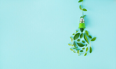 Eco lightbulb from green leaves top view. Renewable and saving energy concept. Ecology and...