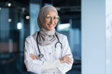 Portrait of Arabic female doctor in modern clinic, Muslim woman wearing hijab glasses and white...
